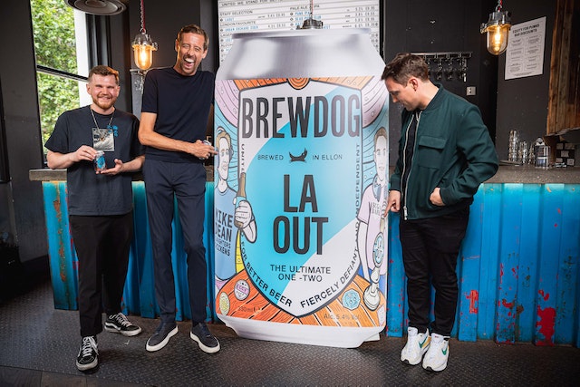 Peter Crouch and BrewDog pose with banner advertising BrewDog Laout