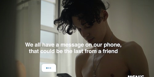 Young male texting a friend in Men's Minds Matter OOH campaign